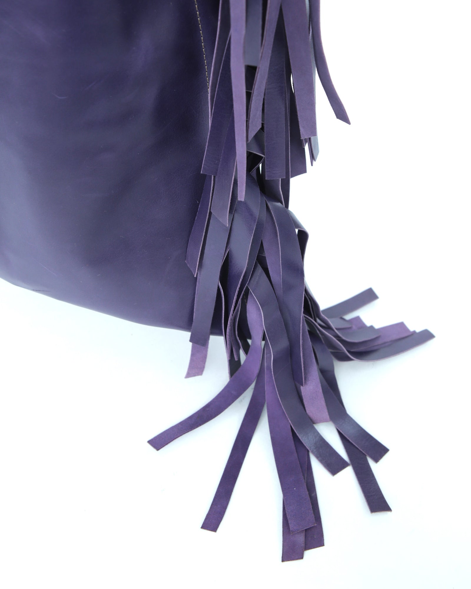 large violet leather tote bag with fringe detail