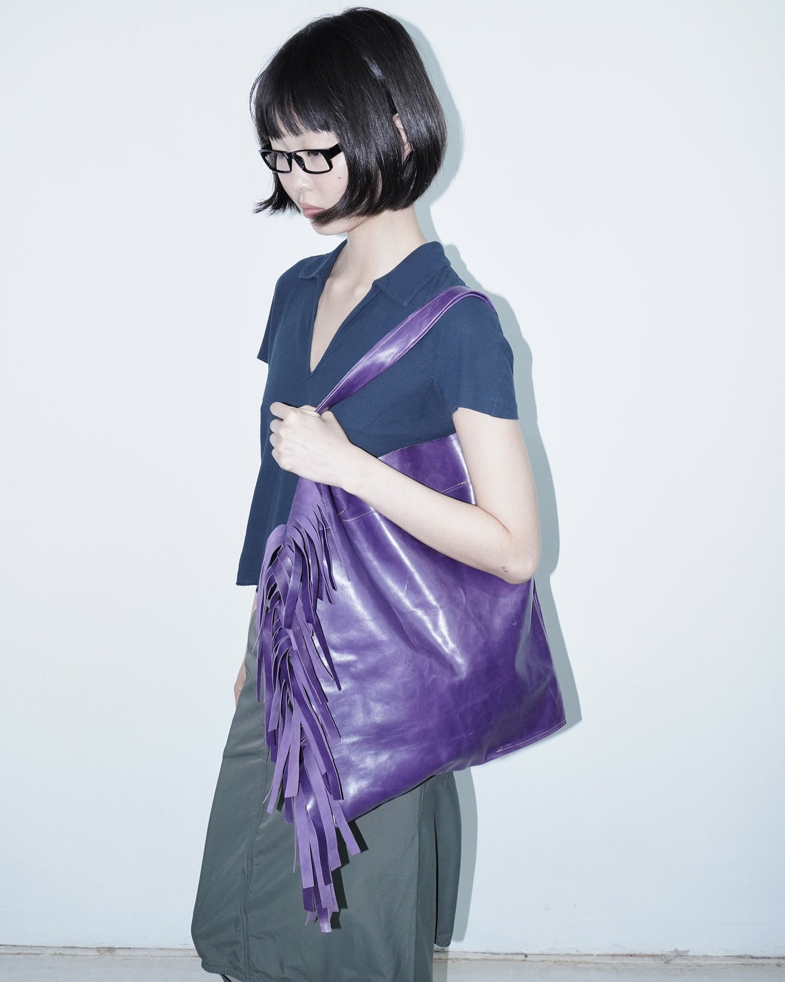 large violet leather tote bag with fringe detail