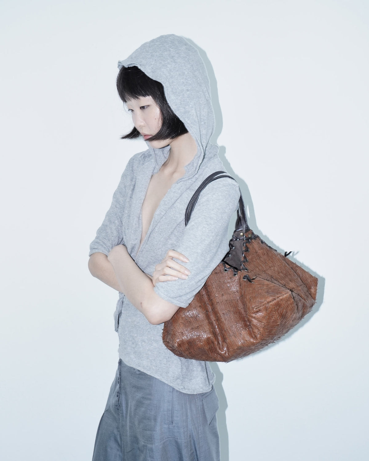 brown and black geometric textured leather bag
