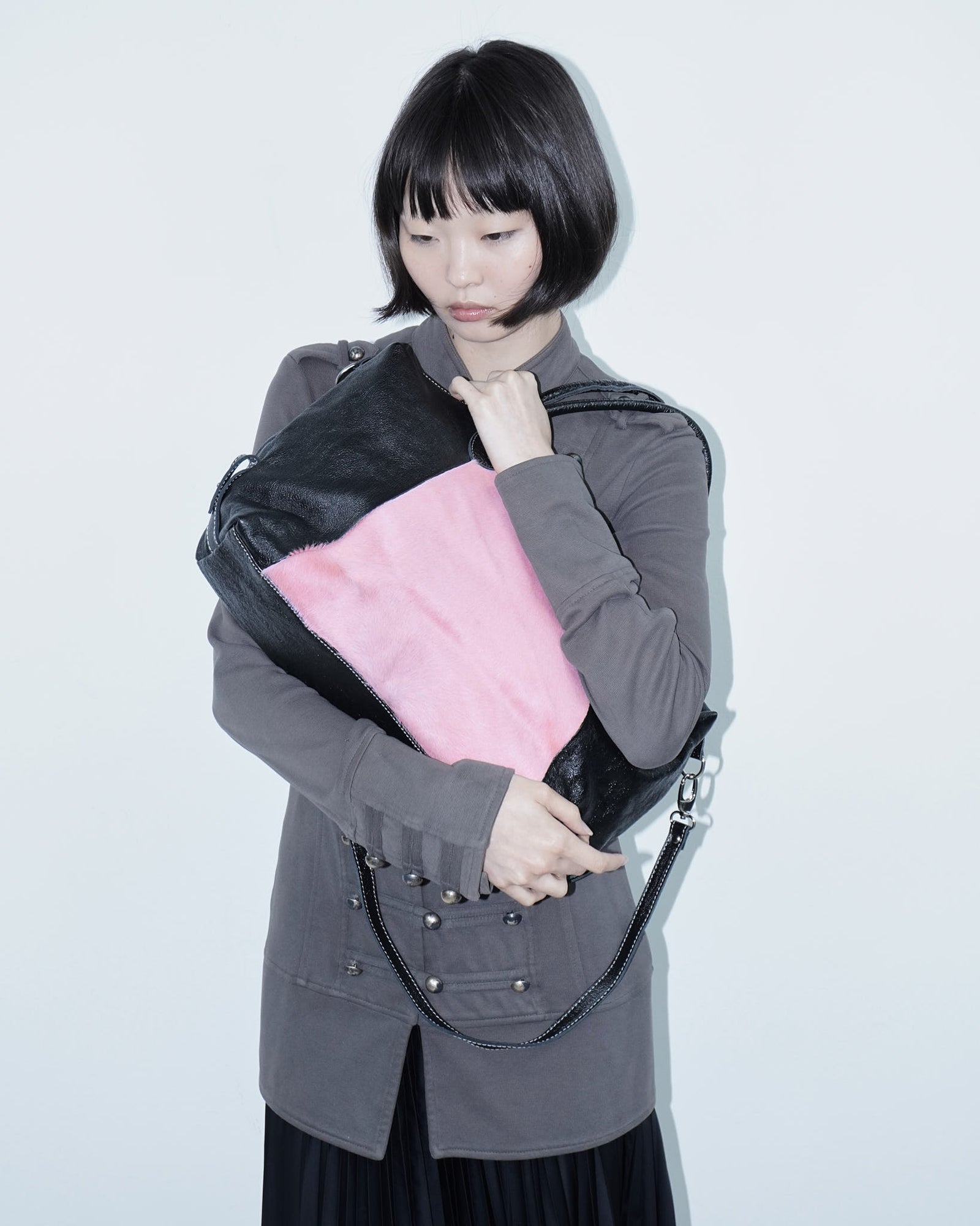 pink pony hair and black shiny leather bag