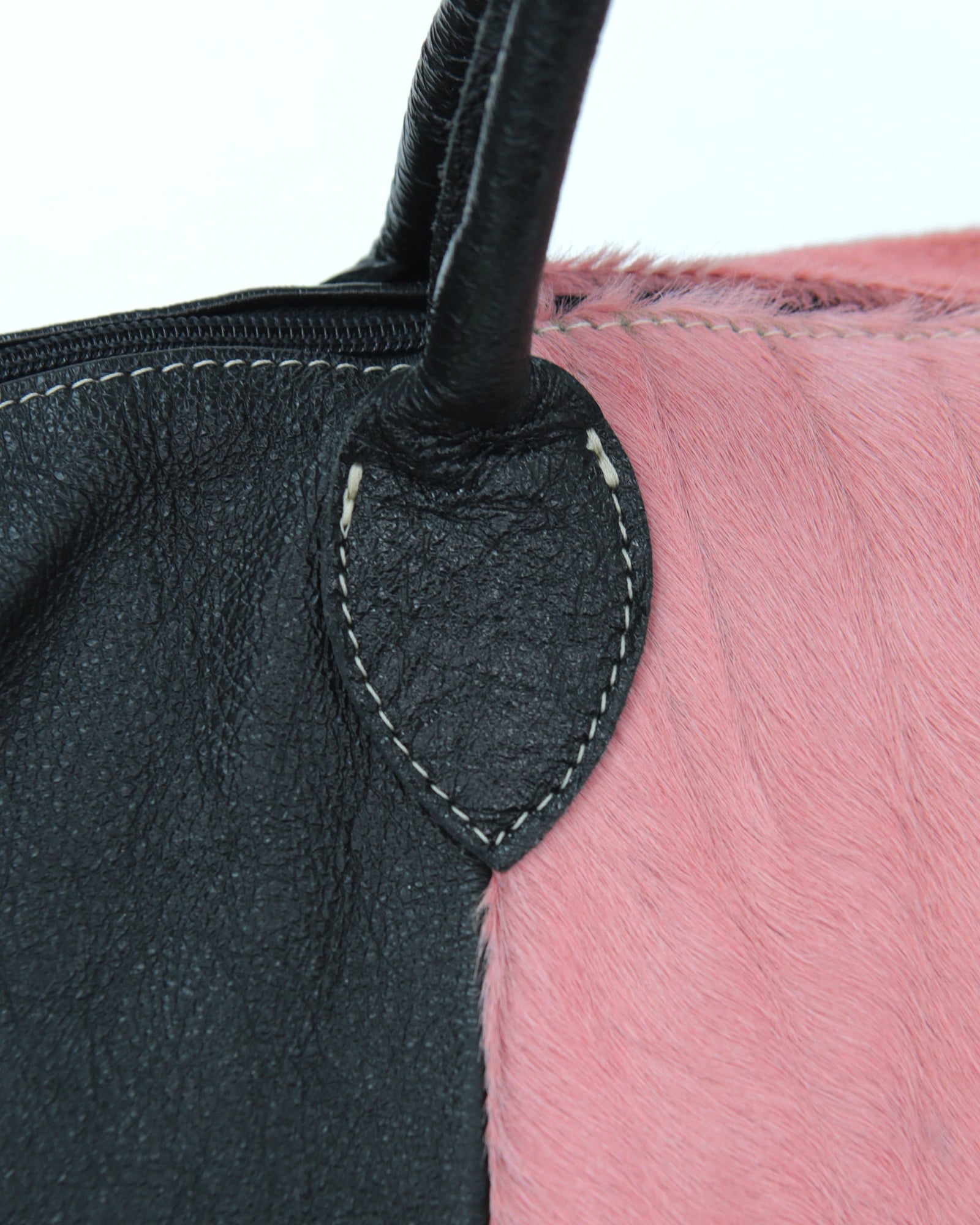 pink pony hair and black shiny leather bag