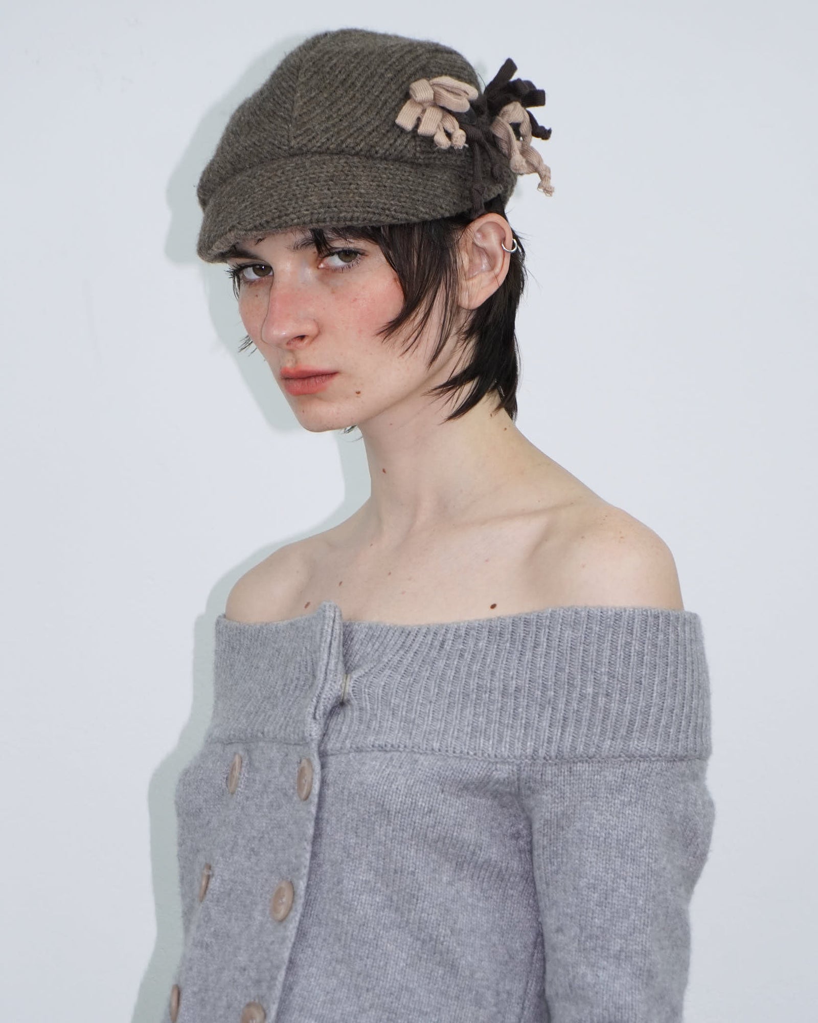 brown knit cap with floral detail