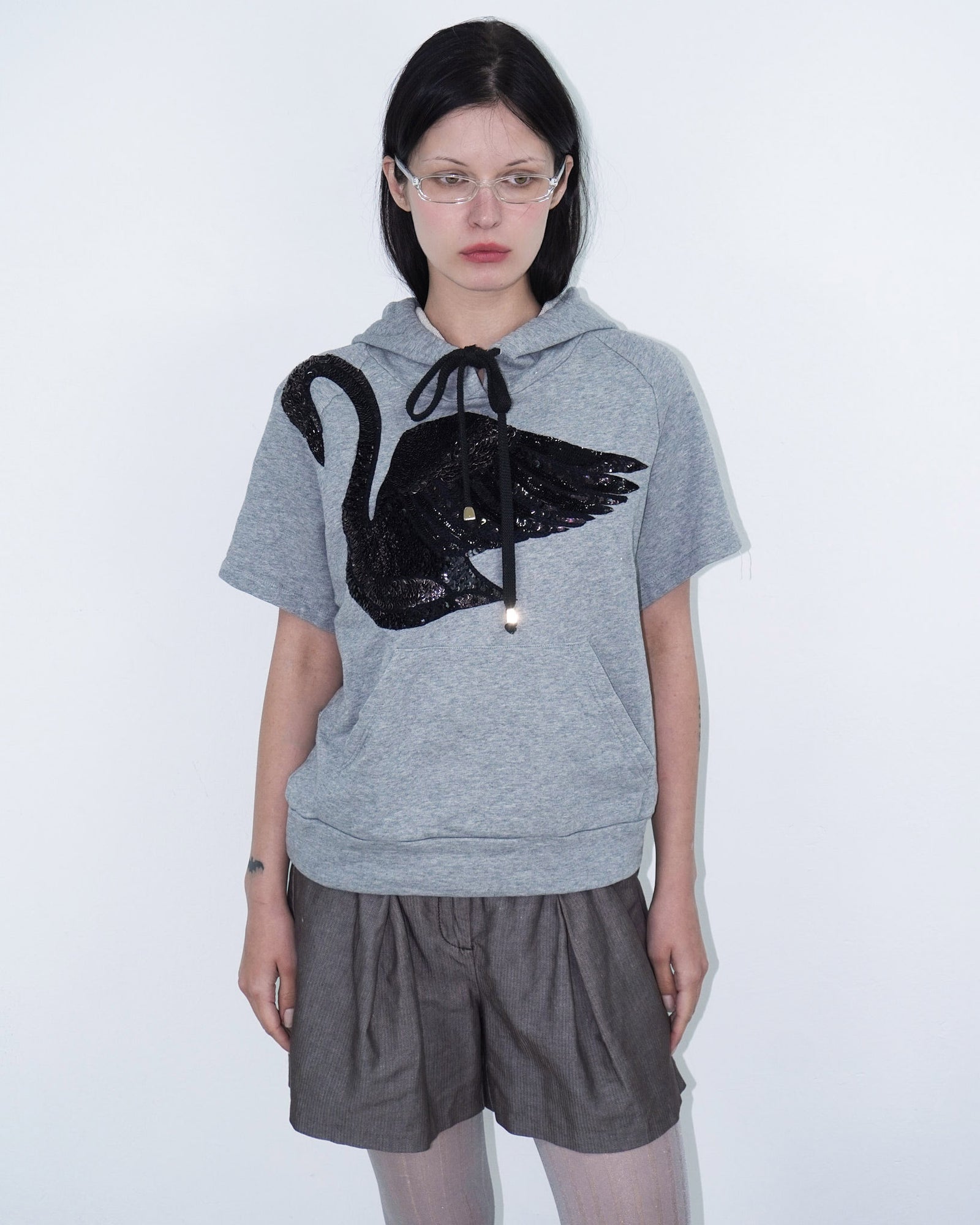 grey hooded top with sequin swan