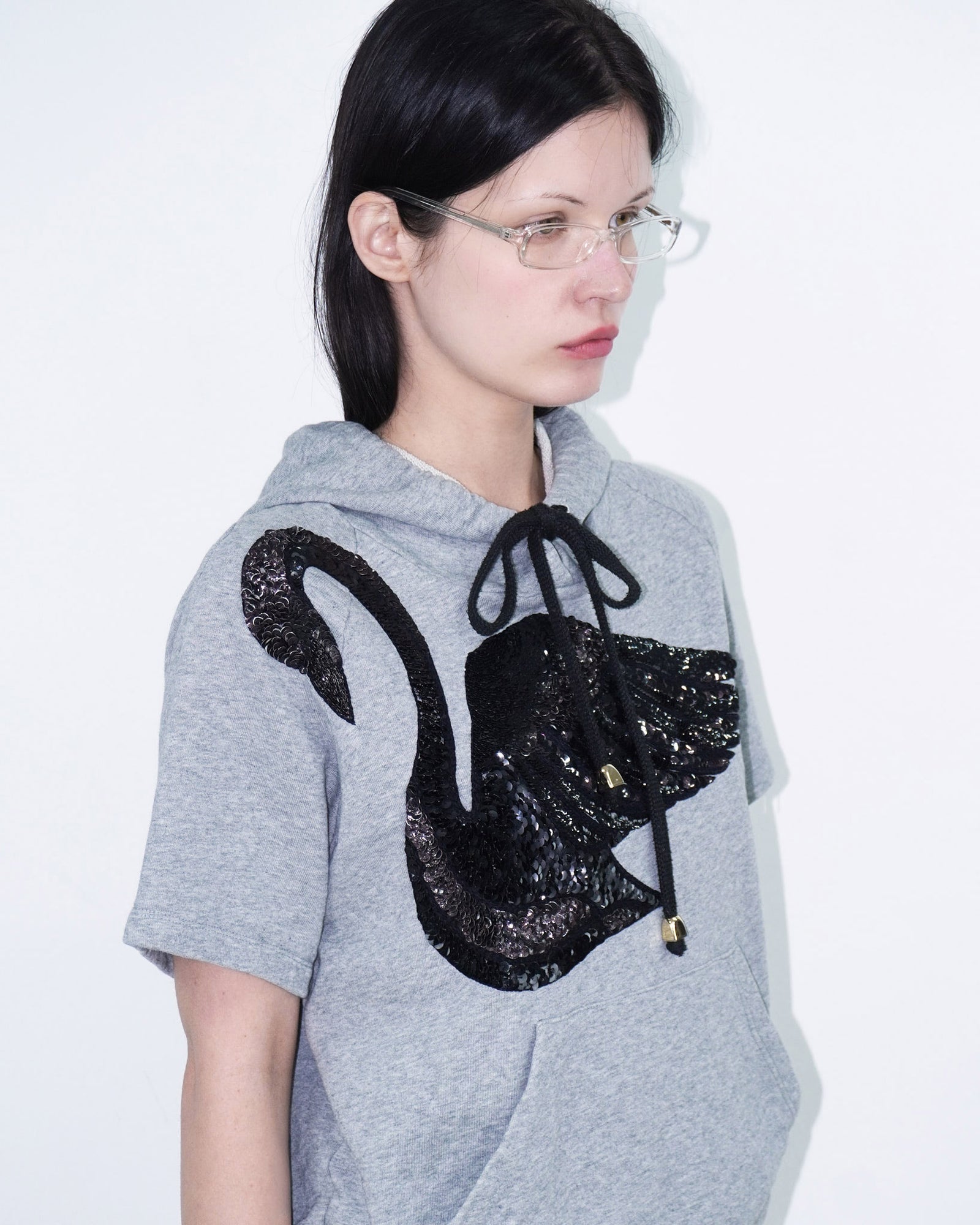 grey hooded top with sequin swan