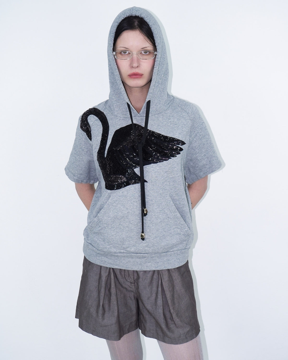 grey hooded top with sequin swan