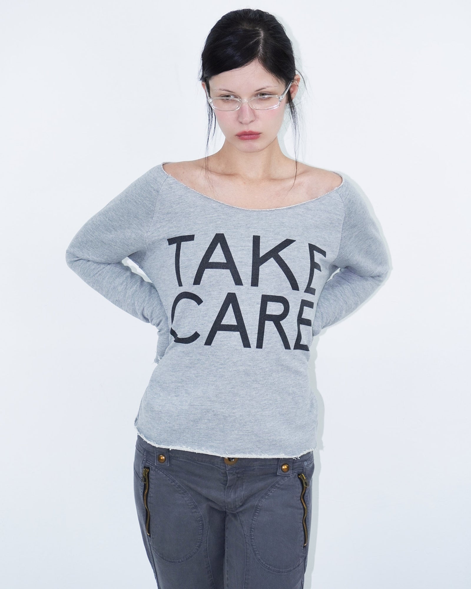 grey off shoulder top with graphical writing