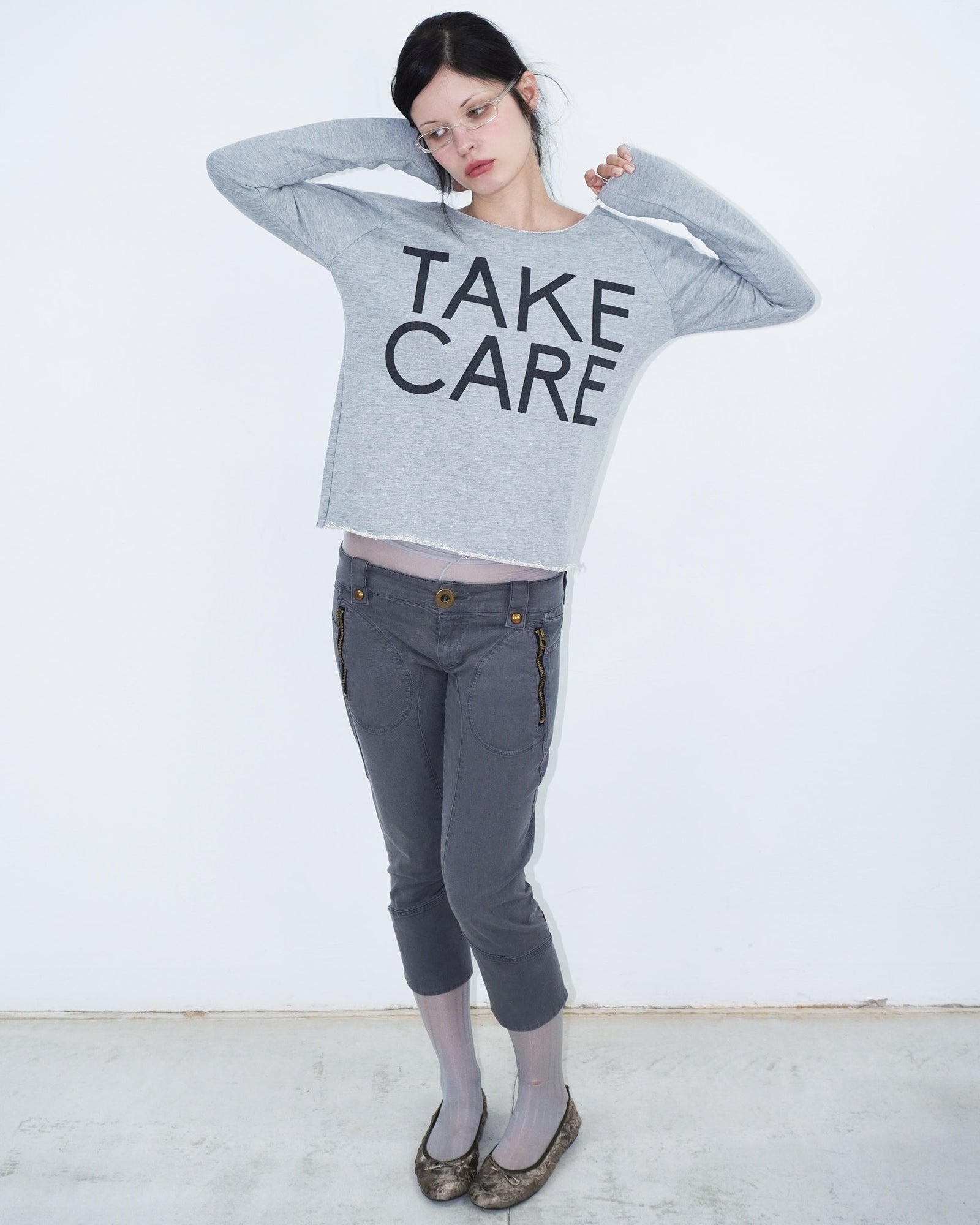 grey off shoulder top with graphical writing