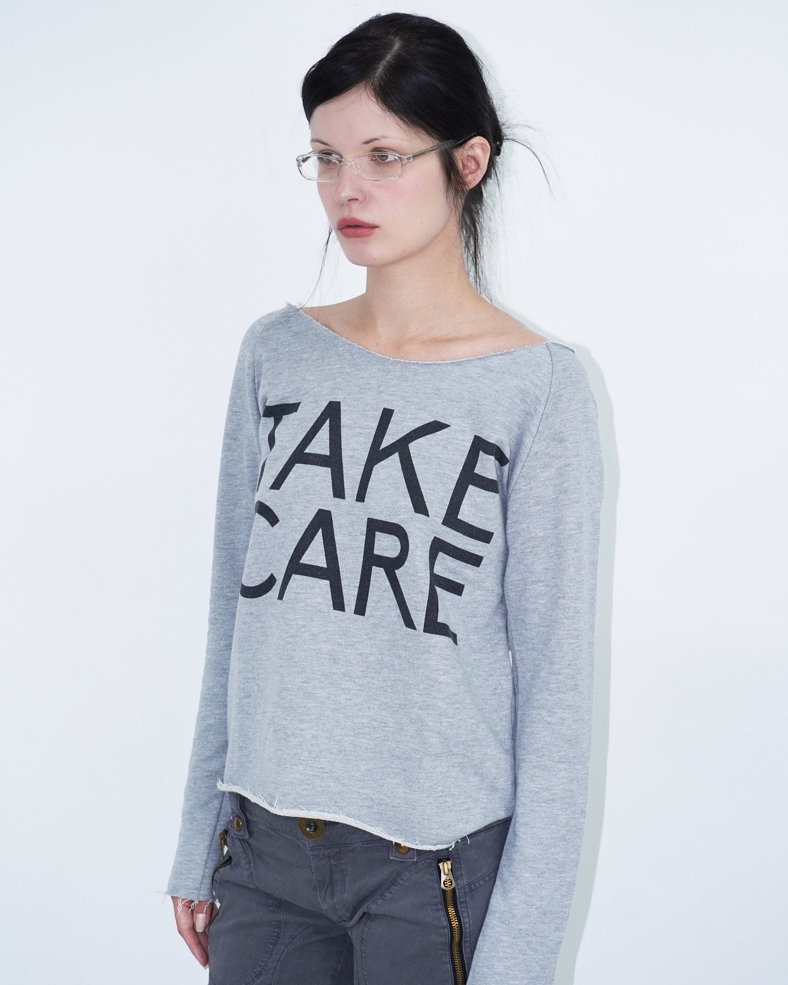 grey off shoulder top with graphical writing