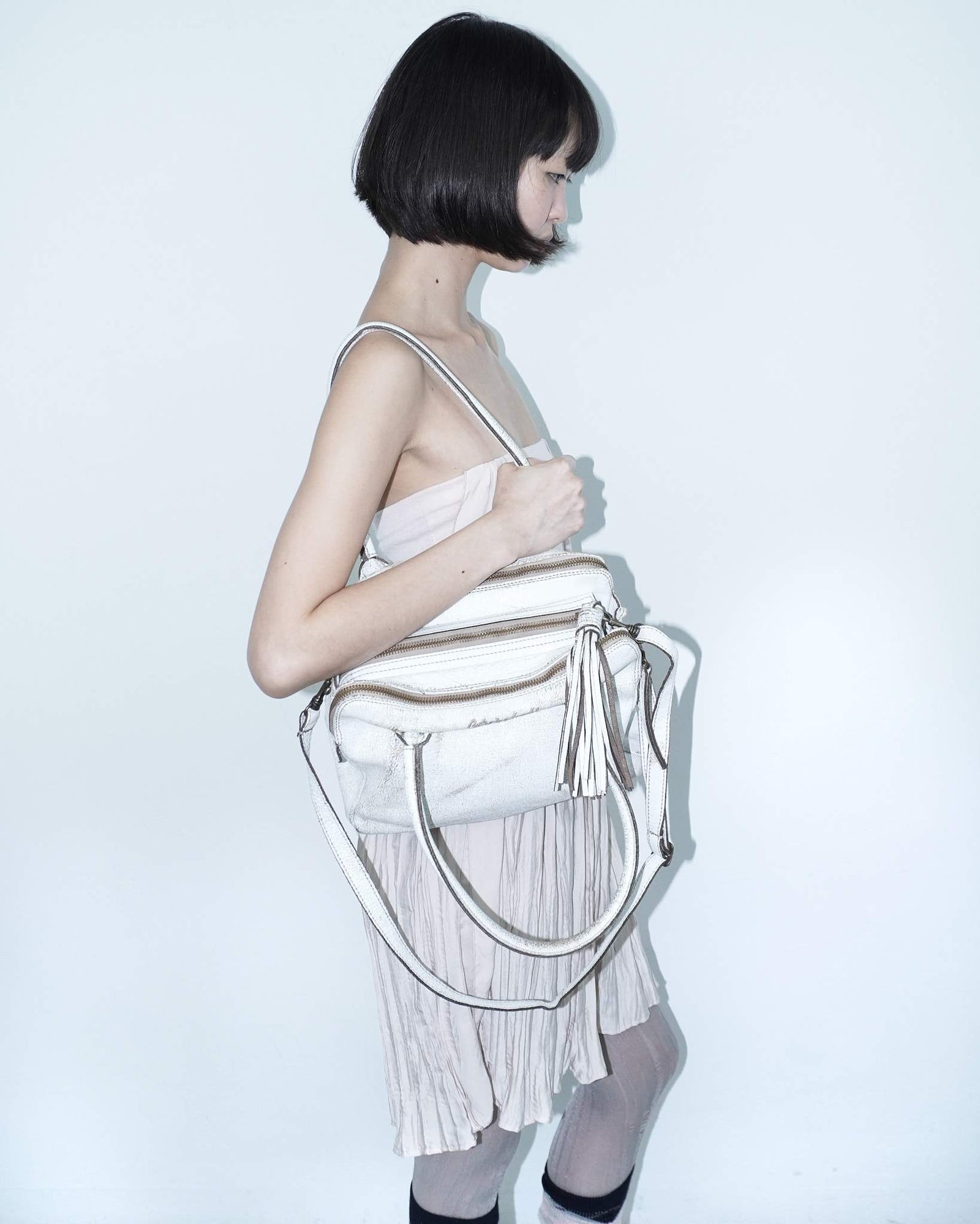 multi zipper distressed white leather bag