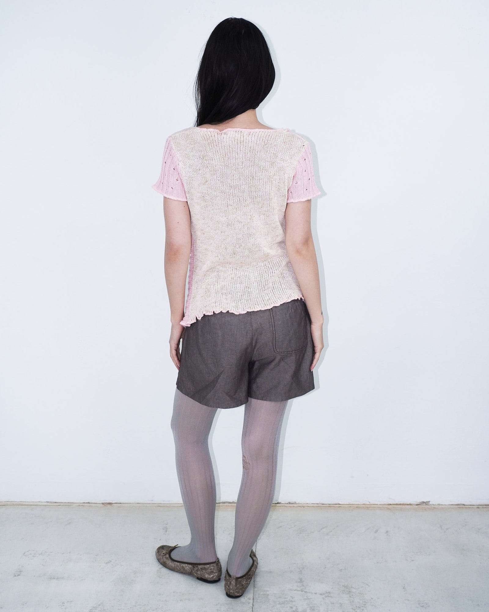 pink knit top with wooden buttons