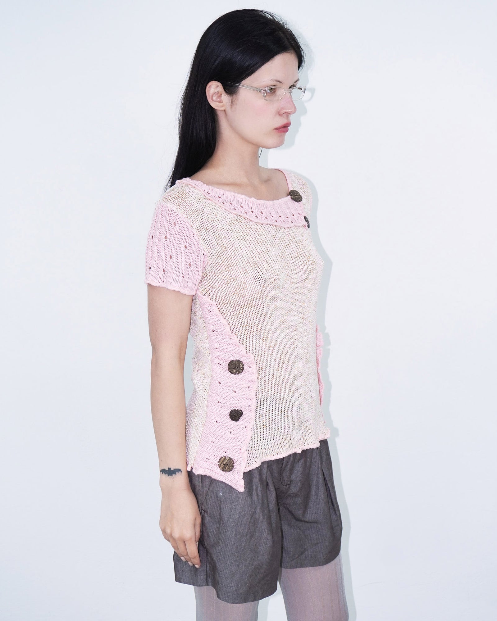 pink knit top with wooden buttons