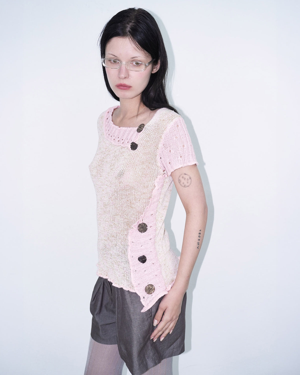 pink knit top with wooden buttons