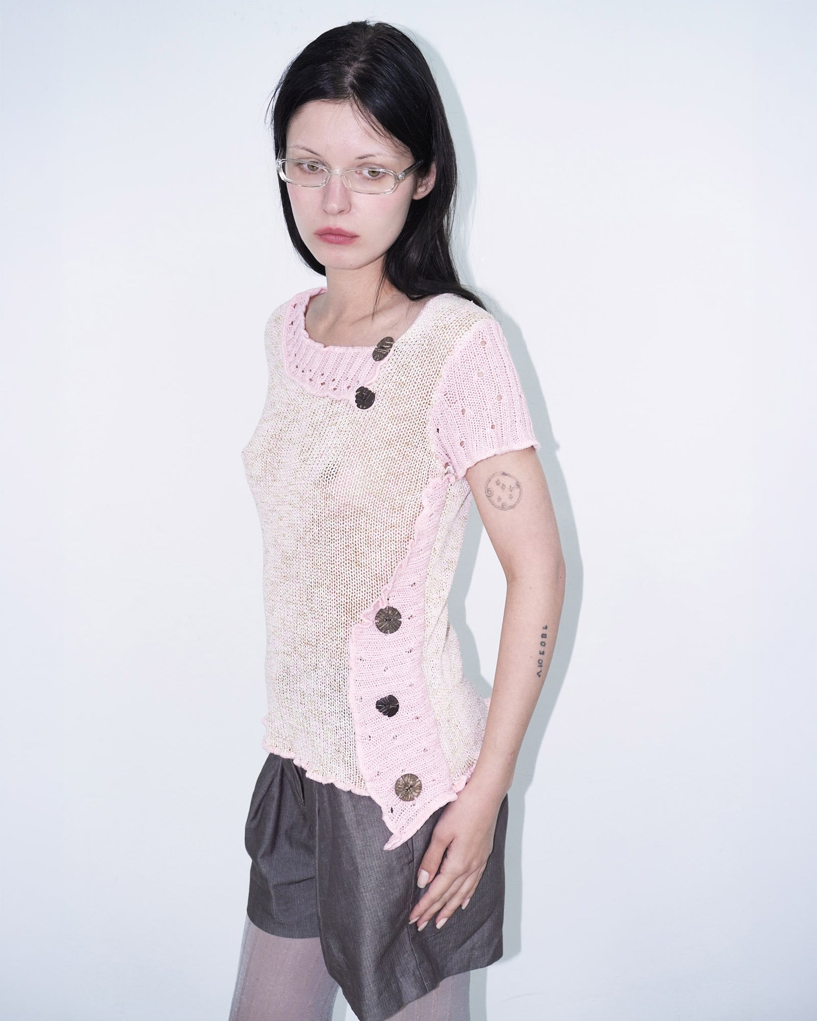 pink knit top with wooden buttons