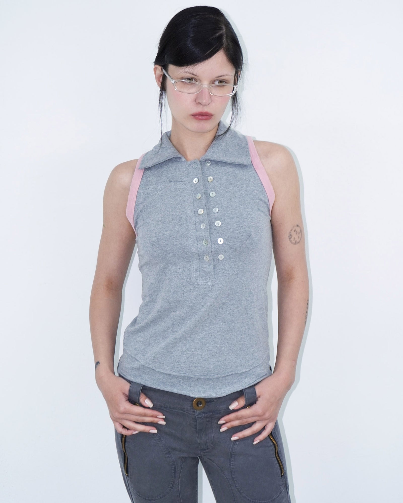 sleeveless polo top with double-breasted buttons and pink armhole details