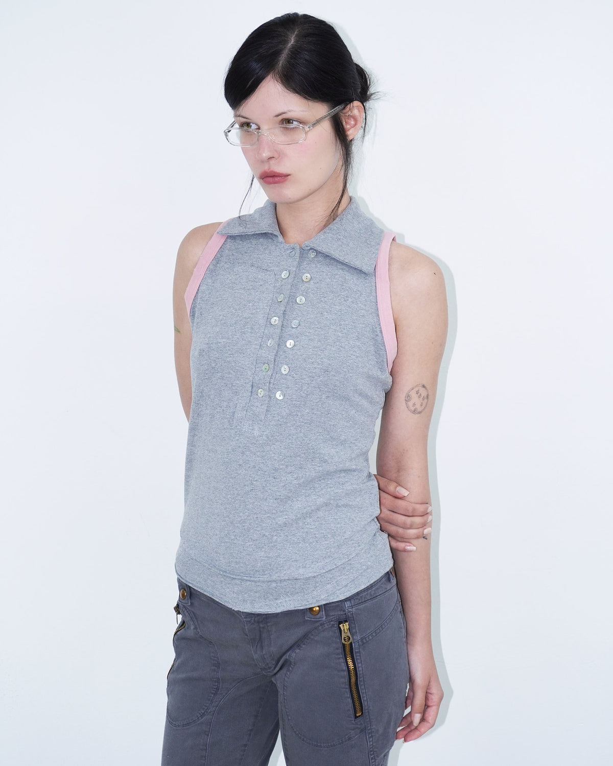 sleeveless polo top with double-breasted buttons and pink armhole details