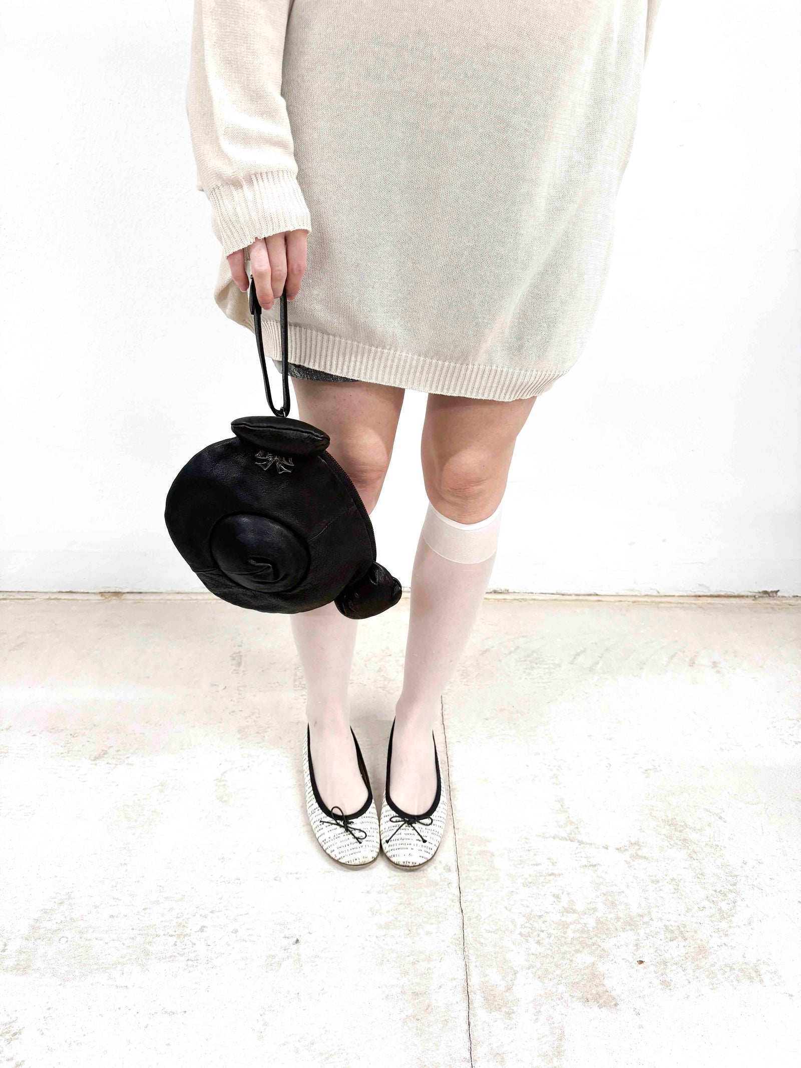 small black leather teddy bear clutch