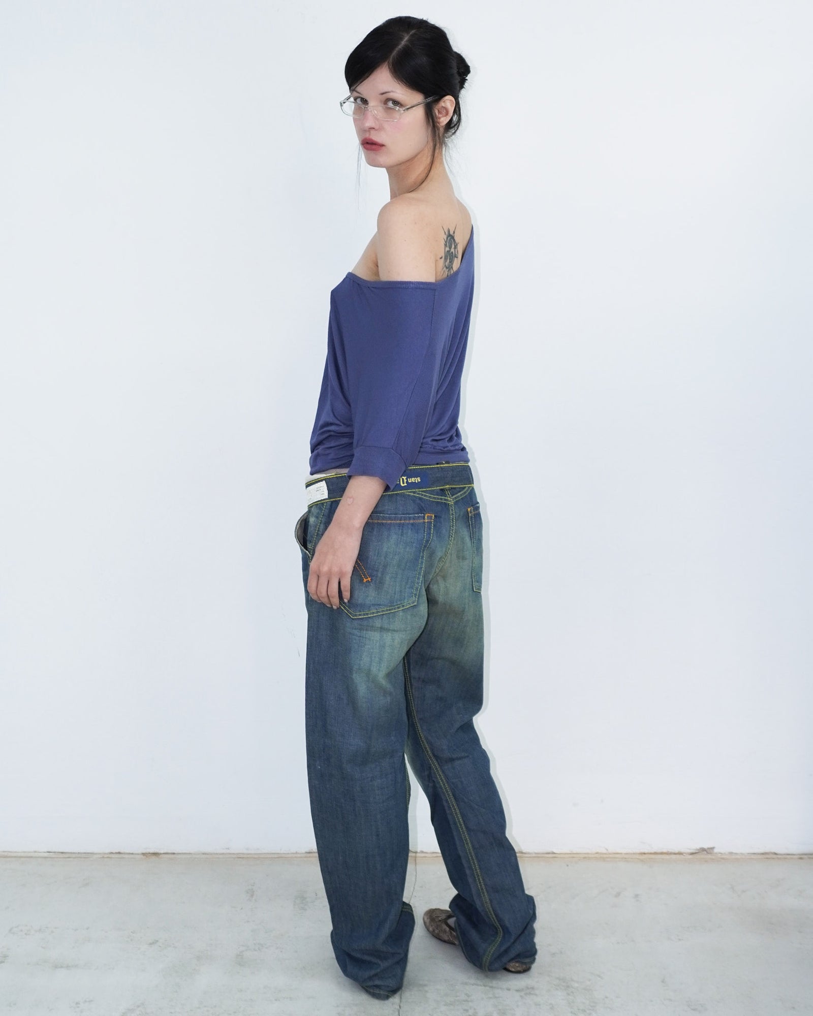 washed denim pants with yellow stitching details