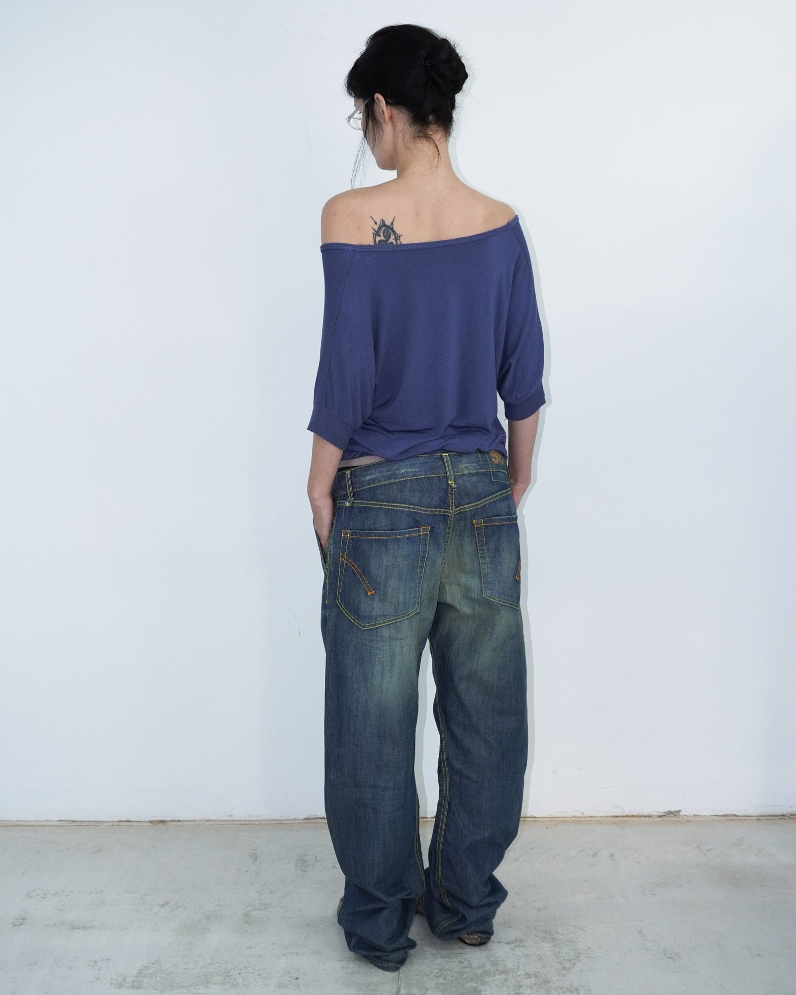 washed denim pants with yellow stitching details