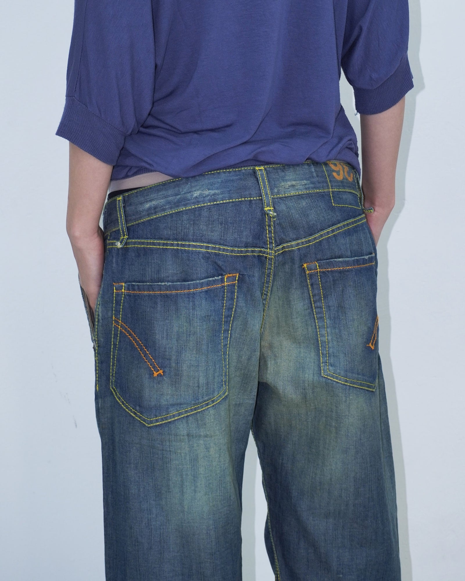 washed denim pants with yellow stitching details