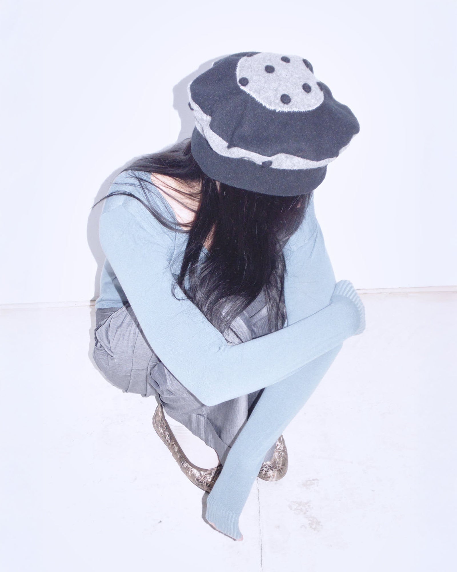black and gray wool felt cloche hat with pom-pom details