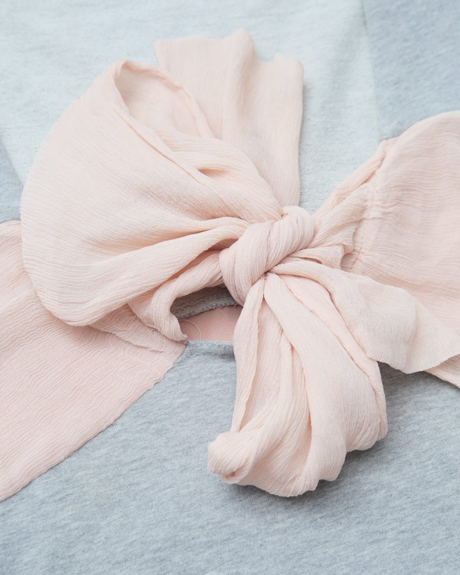 light gray hooded top with pink silk bow