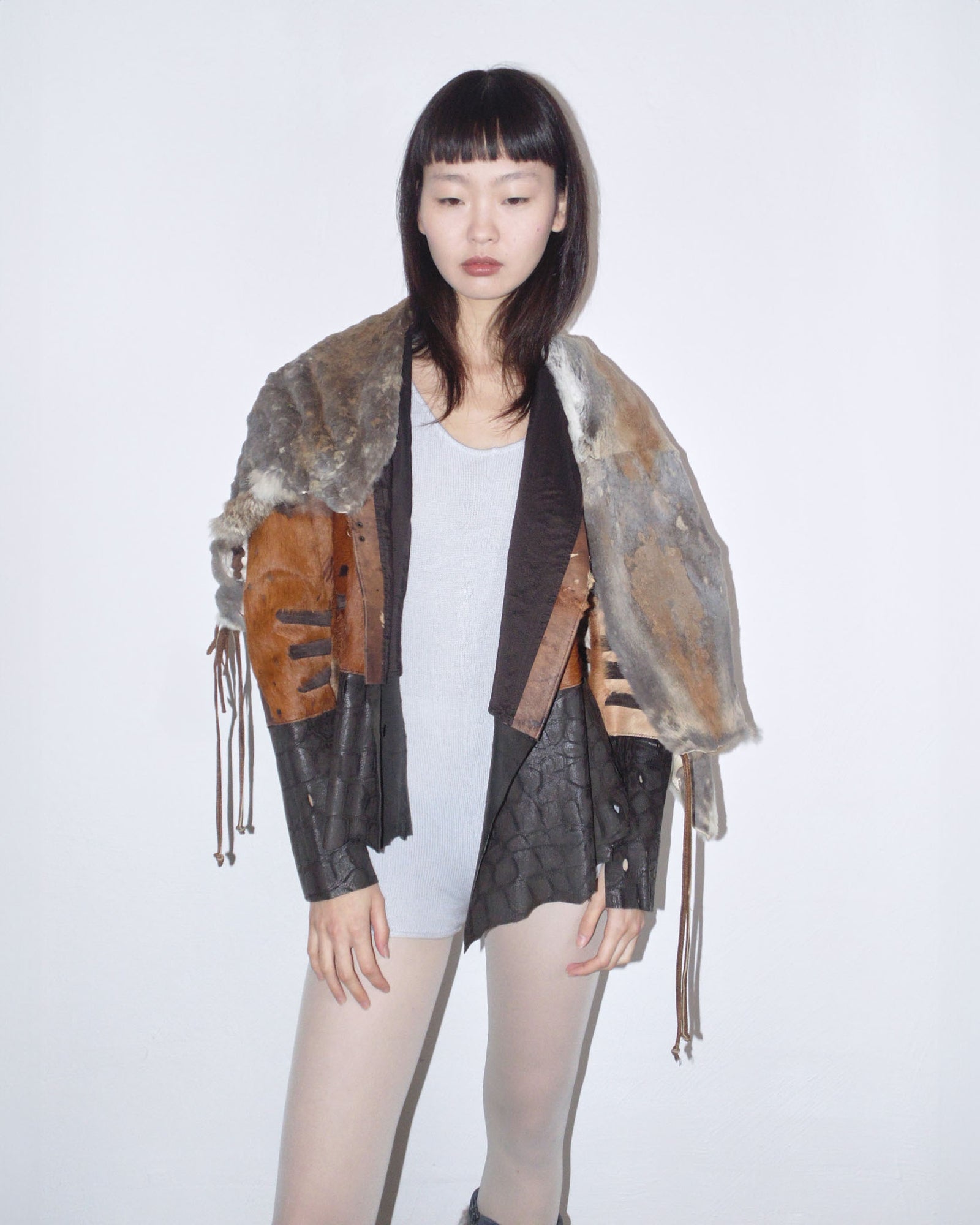raw cut leather and fur patchwork jacket